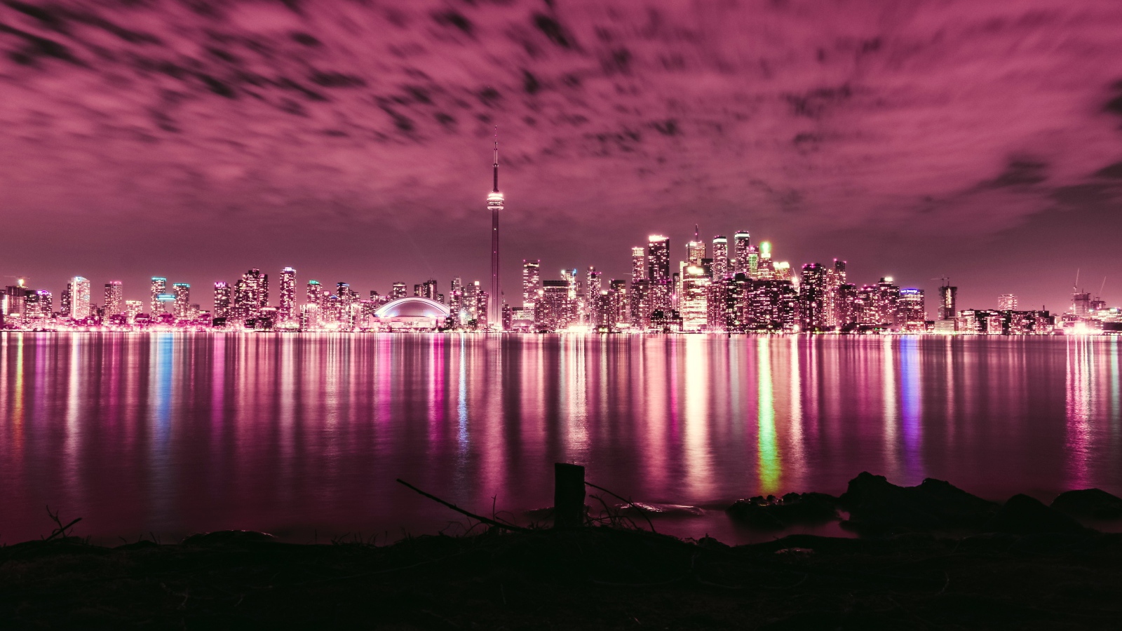 Ночной город под голубым небом отражается в воде 