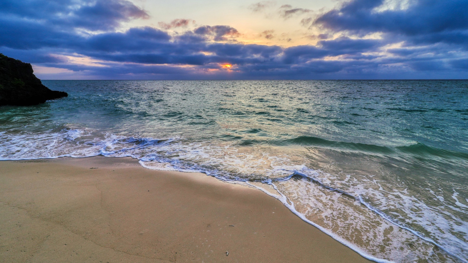 Голубая морская вода на песке на закате солнца