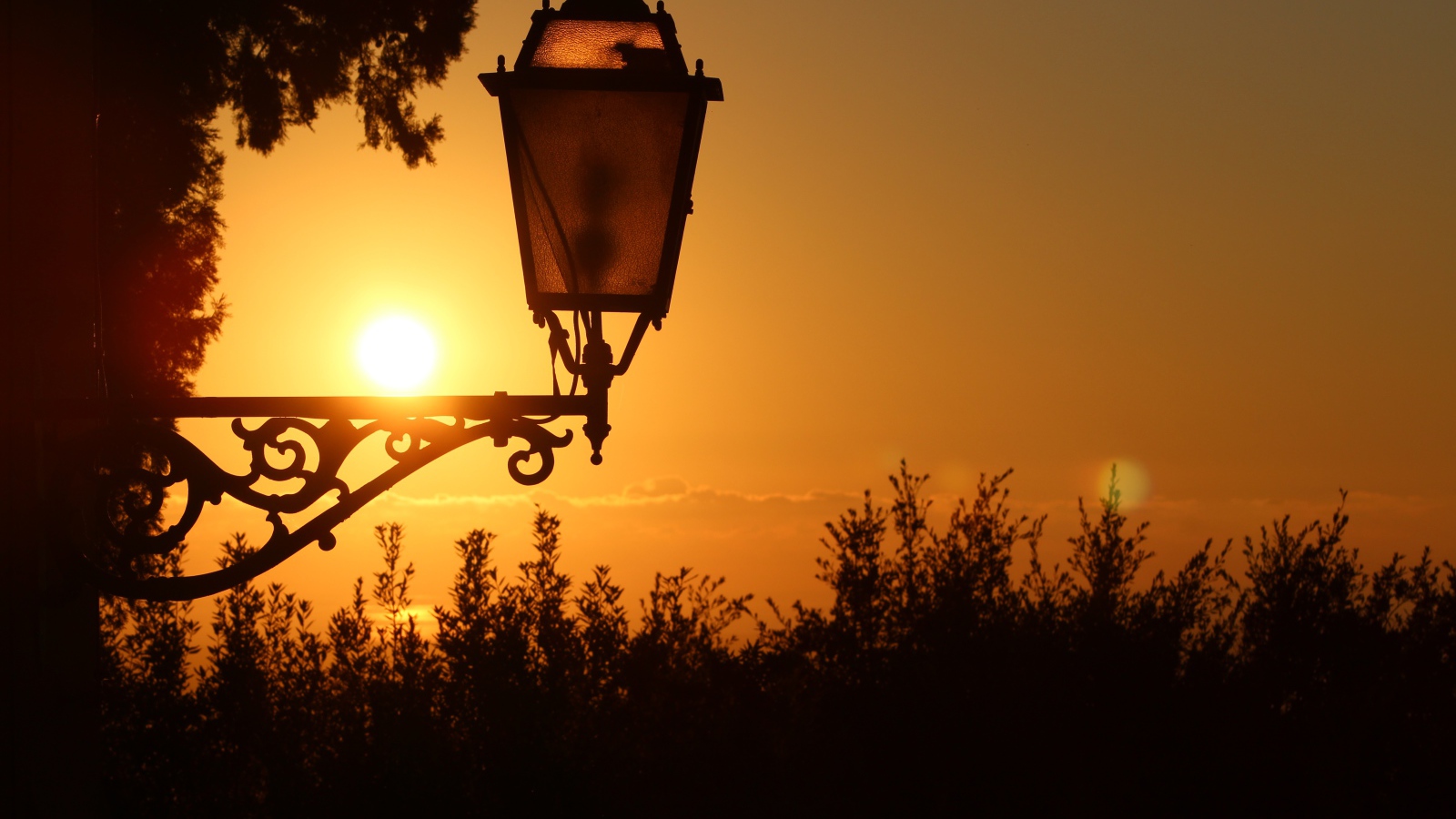 Фонарь на дома на закате солнца