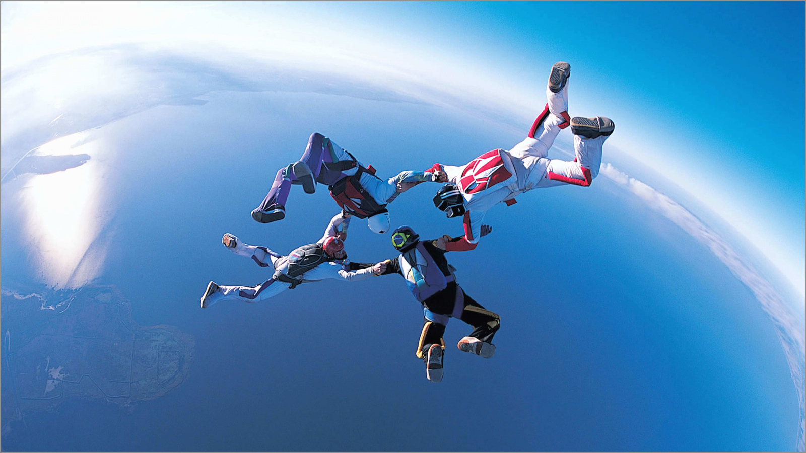 Four skydivers in the air