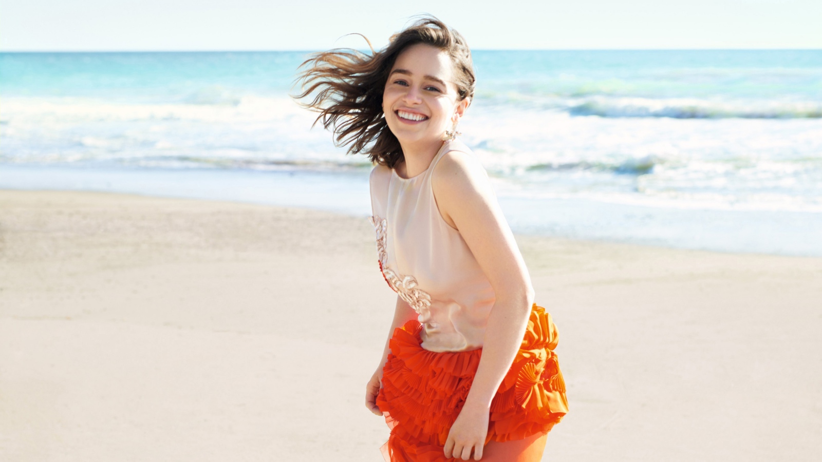 Улыбающаяся девушка, актриса Эмилия Кларк на фоне моря