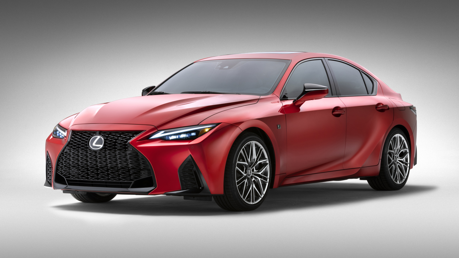 Красный Lexus IS 500 F SPORT Performance, 2022 года на сером фоне