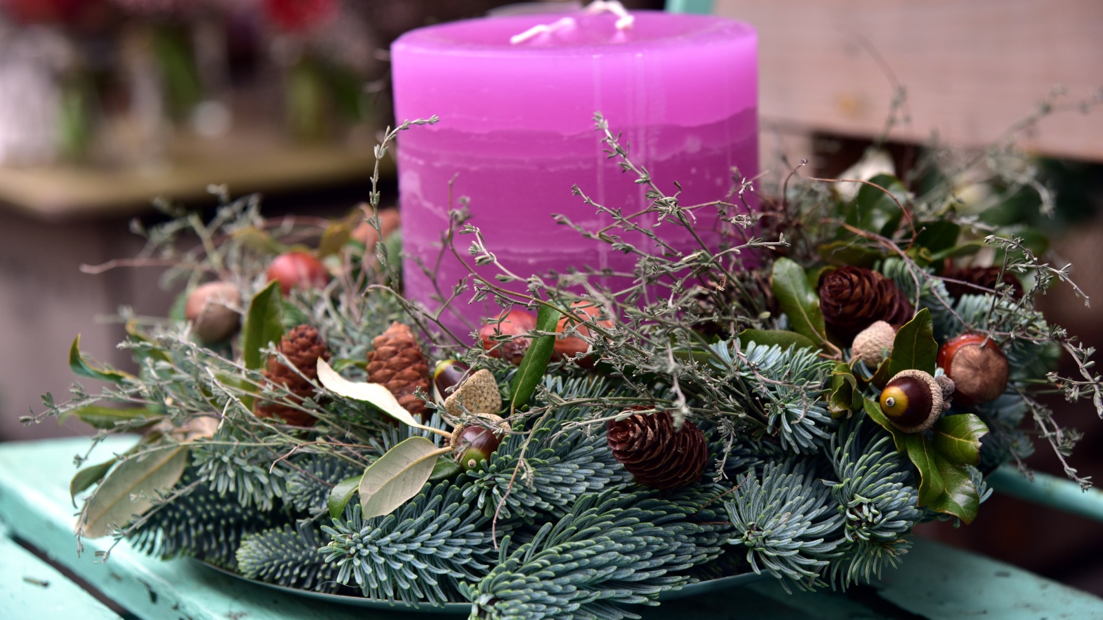 Candle with a wreath on a bench