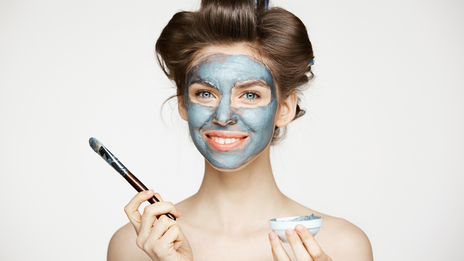 Красивая девушка с косметической маской на лице