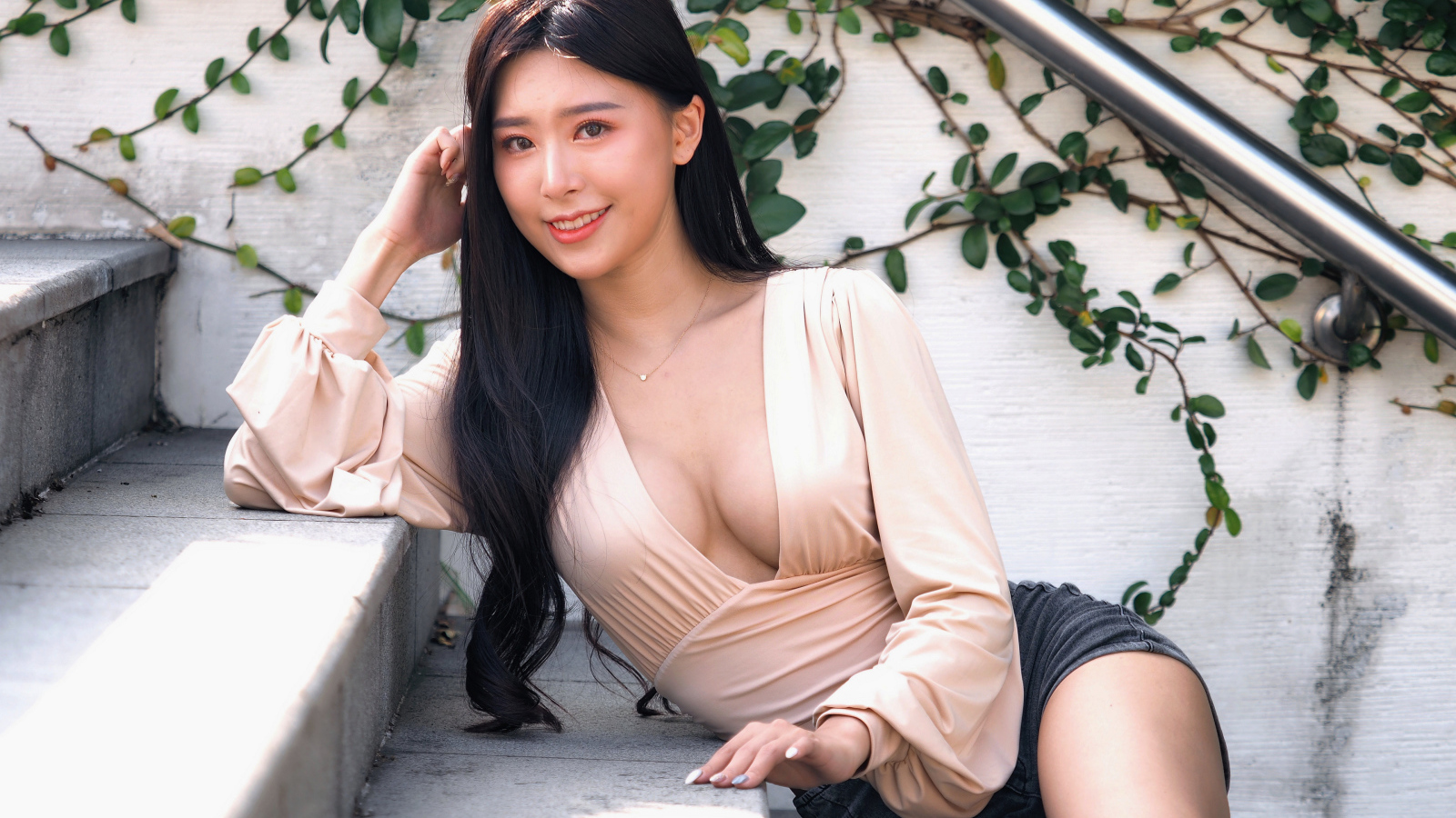 Улыбающаяся девушка азиатка с черными волосами на ступенях 