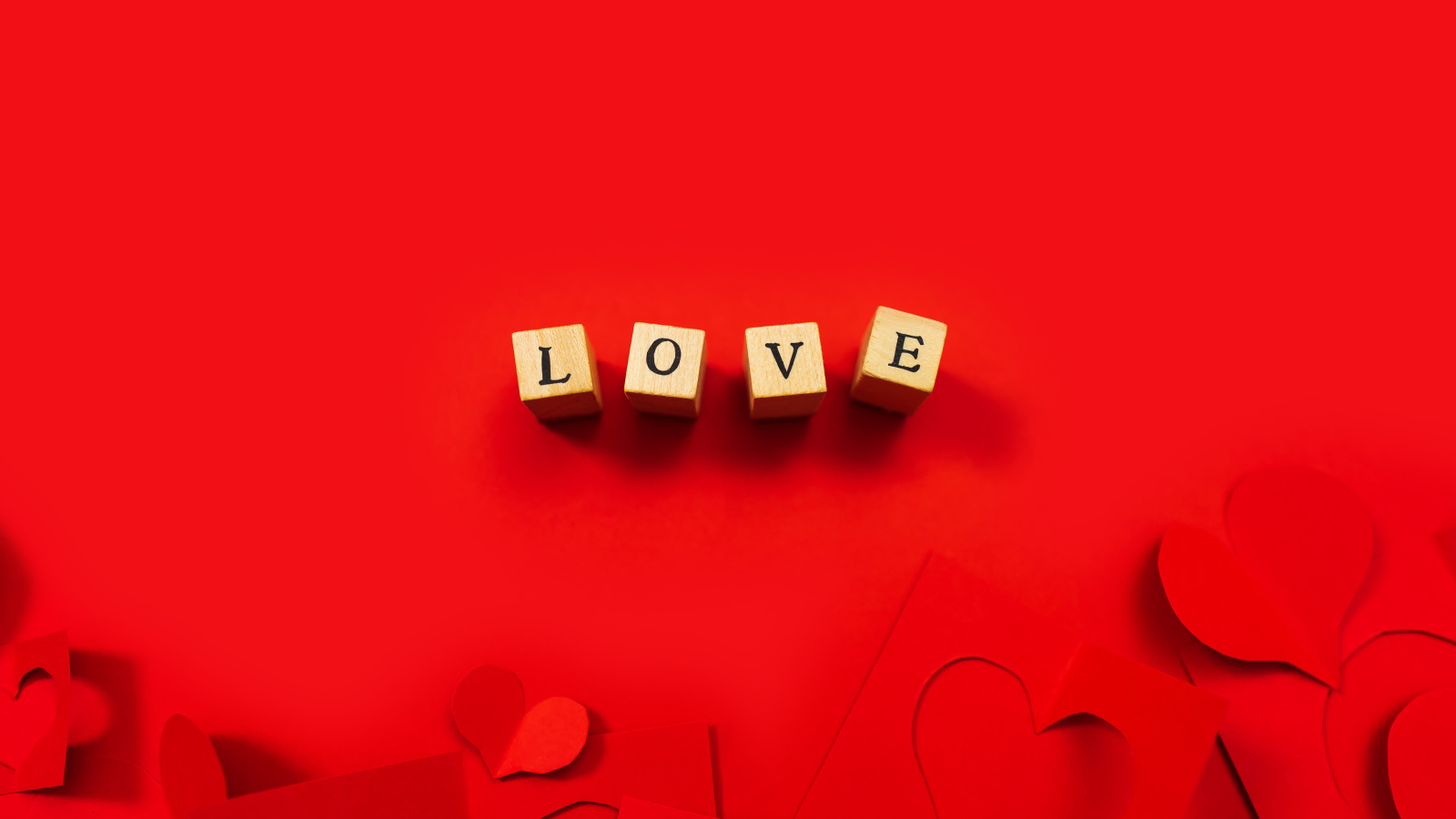 Wooden cubes with the inscription love on a red background