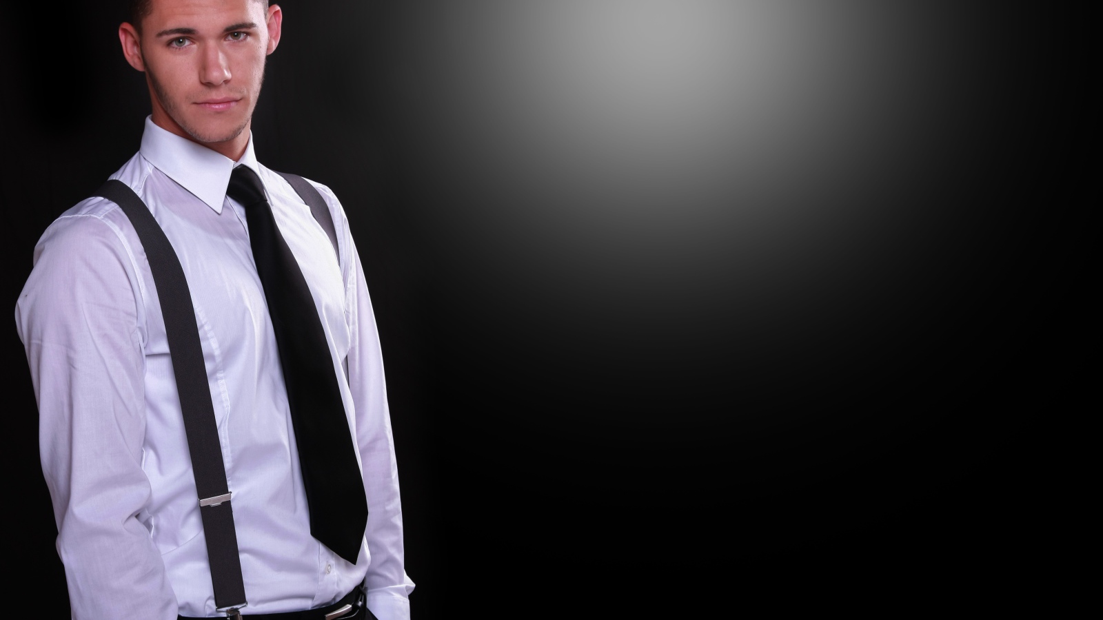 Красивый парень в белой рубашке на черном фоне 