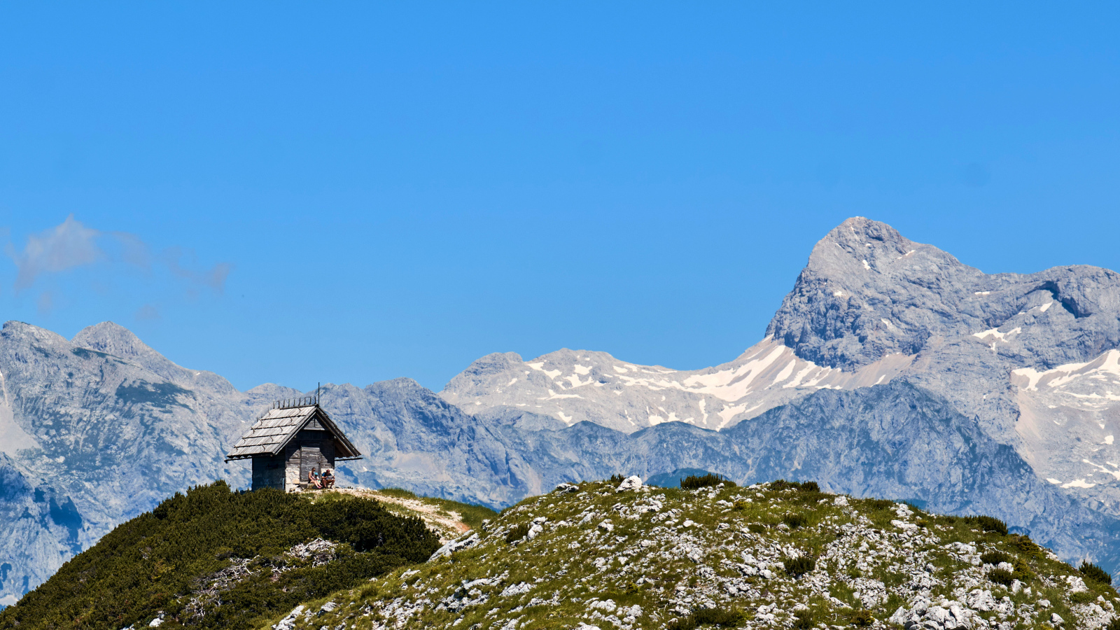 Дом на вершине горы под голубым небом