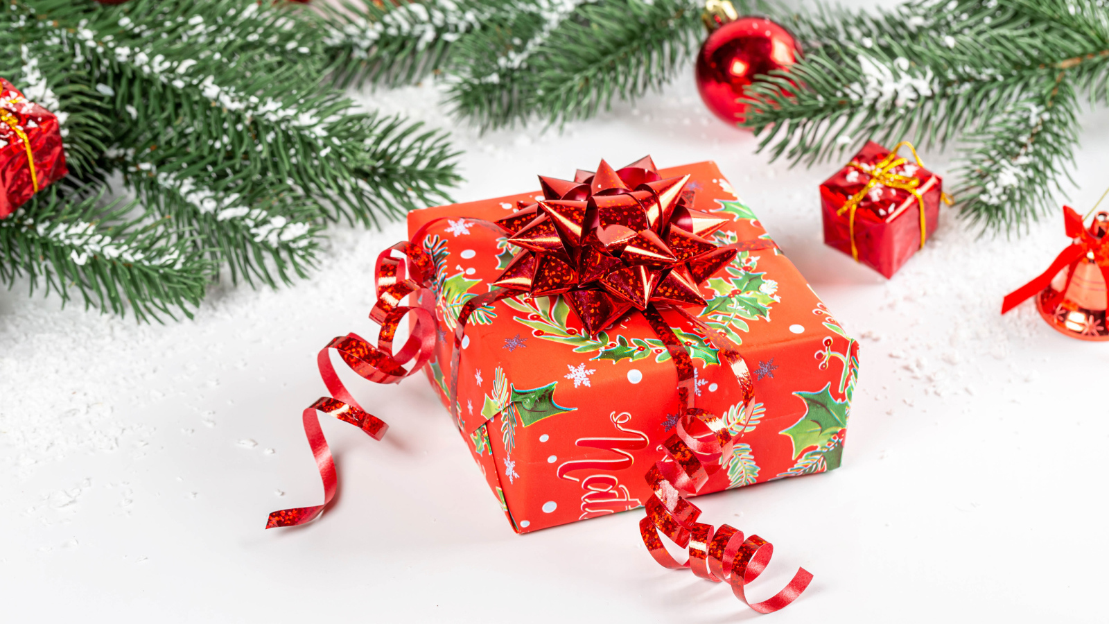 Большой красивый красный подарок с еловой веткой 