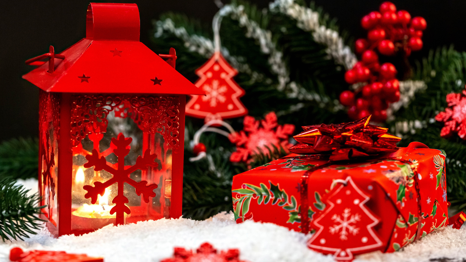 Красный фонарь с подарком у елочной ветки