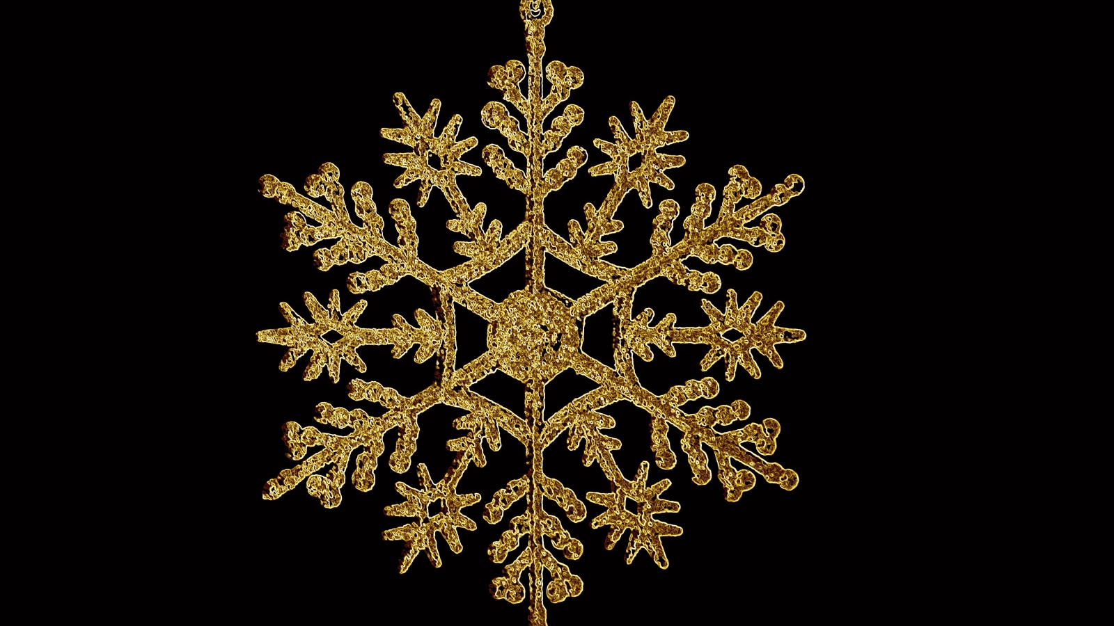 Golden snowflake on black background