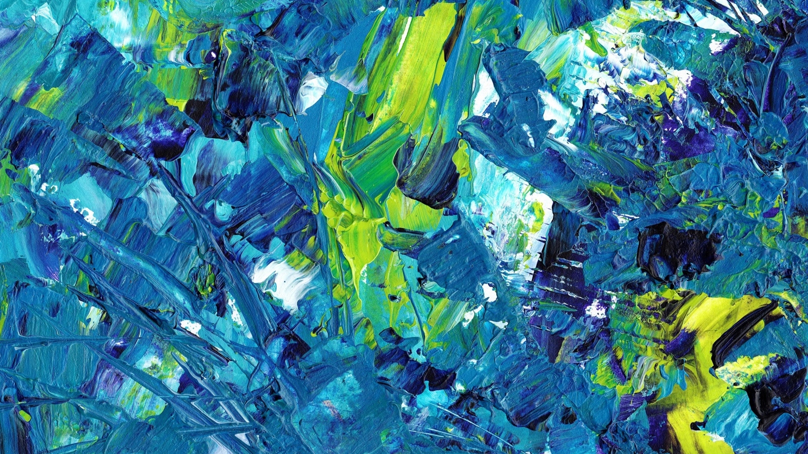 Синие и желтые краски смешанные на палитре