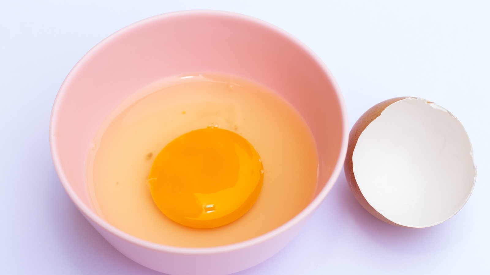 Разбитое яйцо на столе со скорлупой