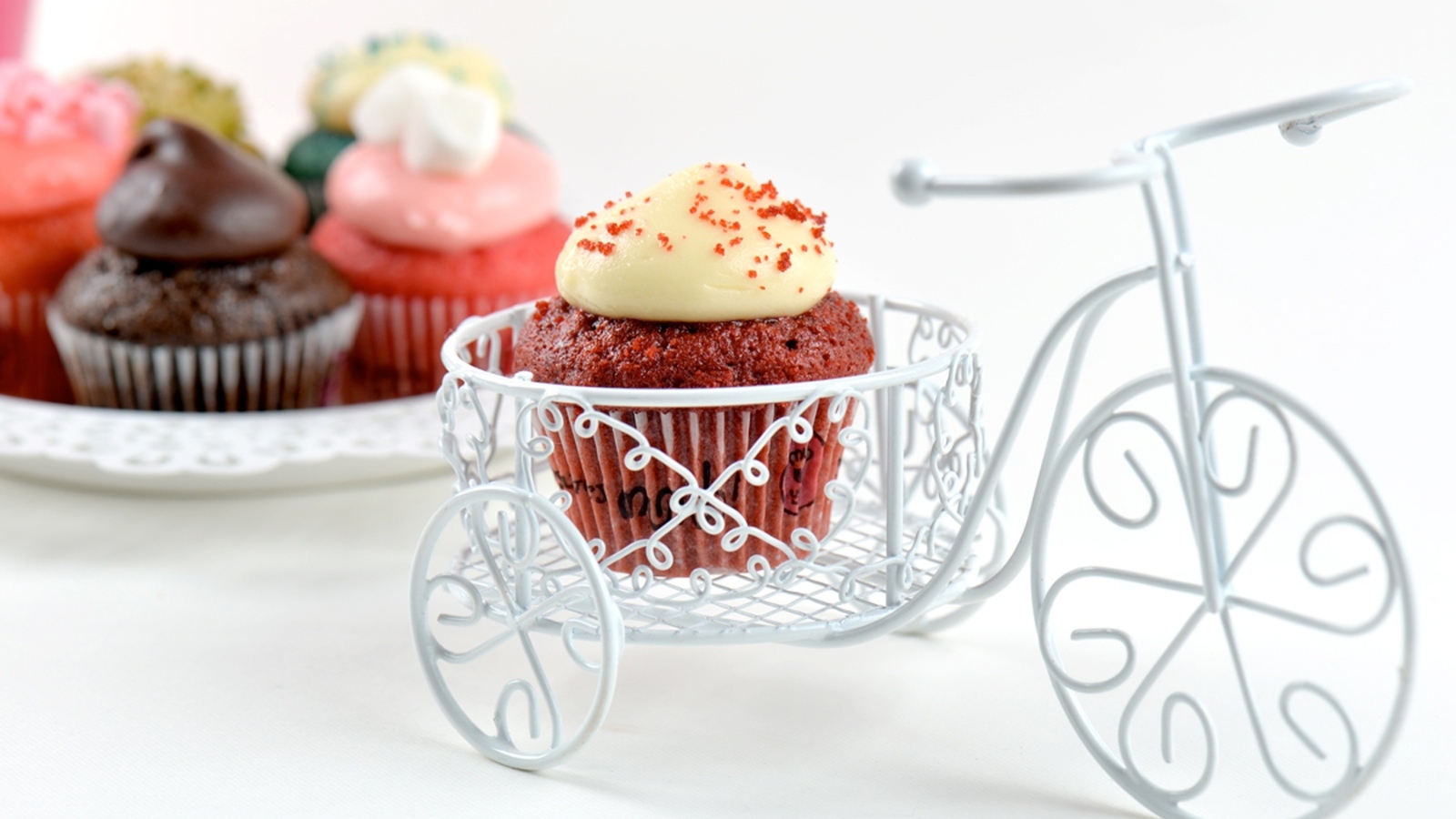 Кекс с кремом с игрушечным велосипедом