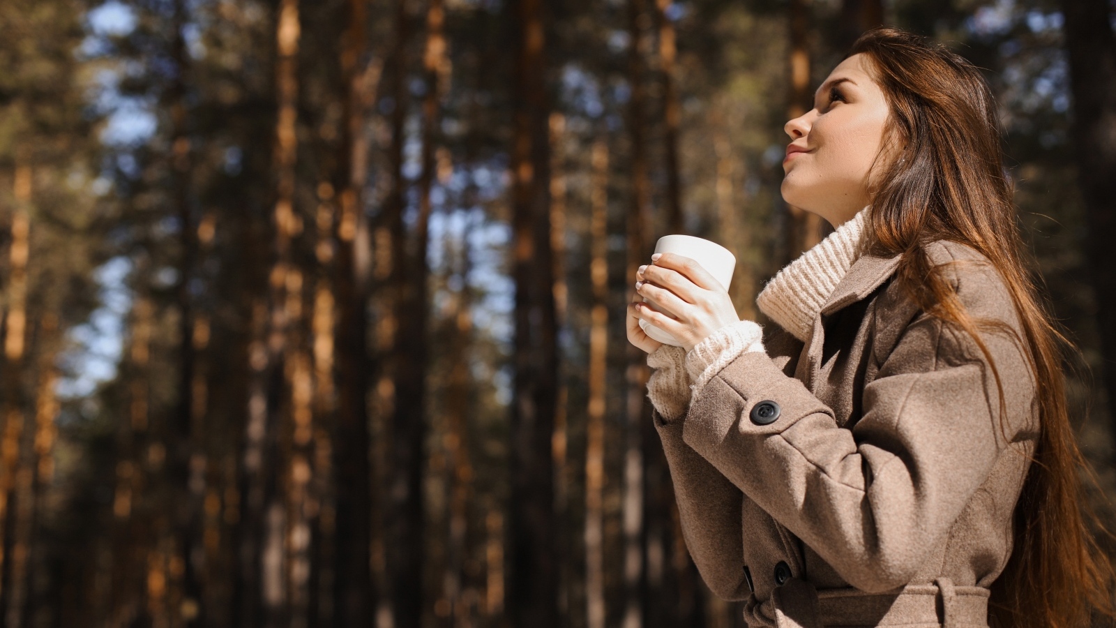 Девушка с чашкой кофе в парке