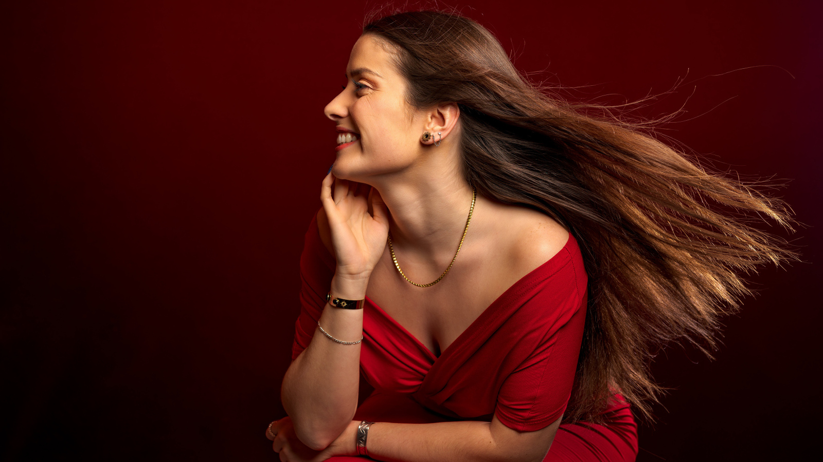 Длинные волосы у красивой девушки в красном платье