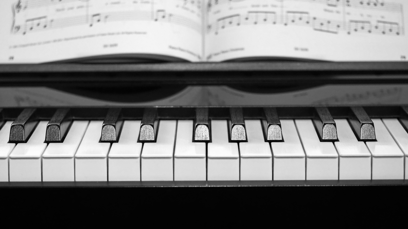 Клавиши пианино с нотной тетрадью