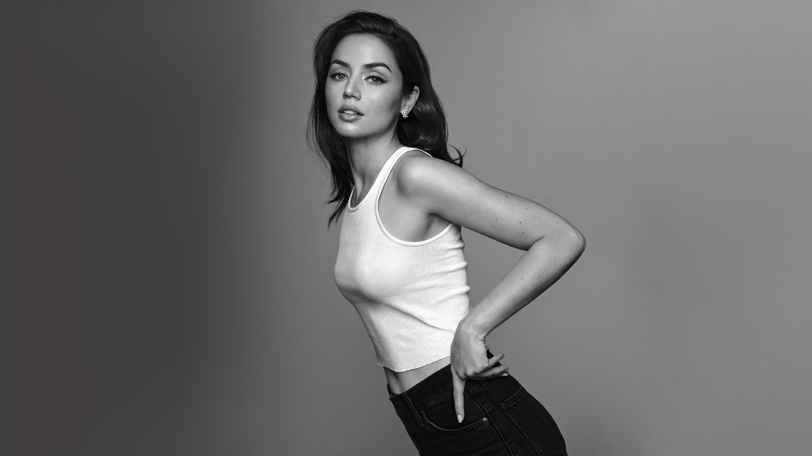 Актриса Ана де Армас в белой майке на сером фоне