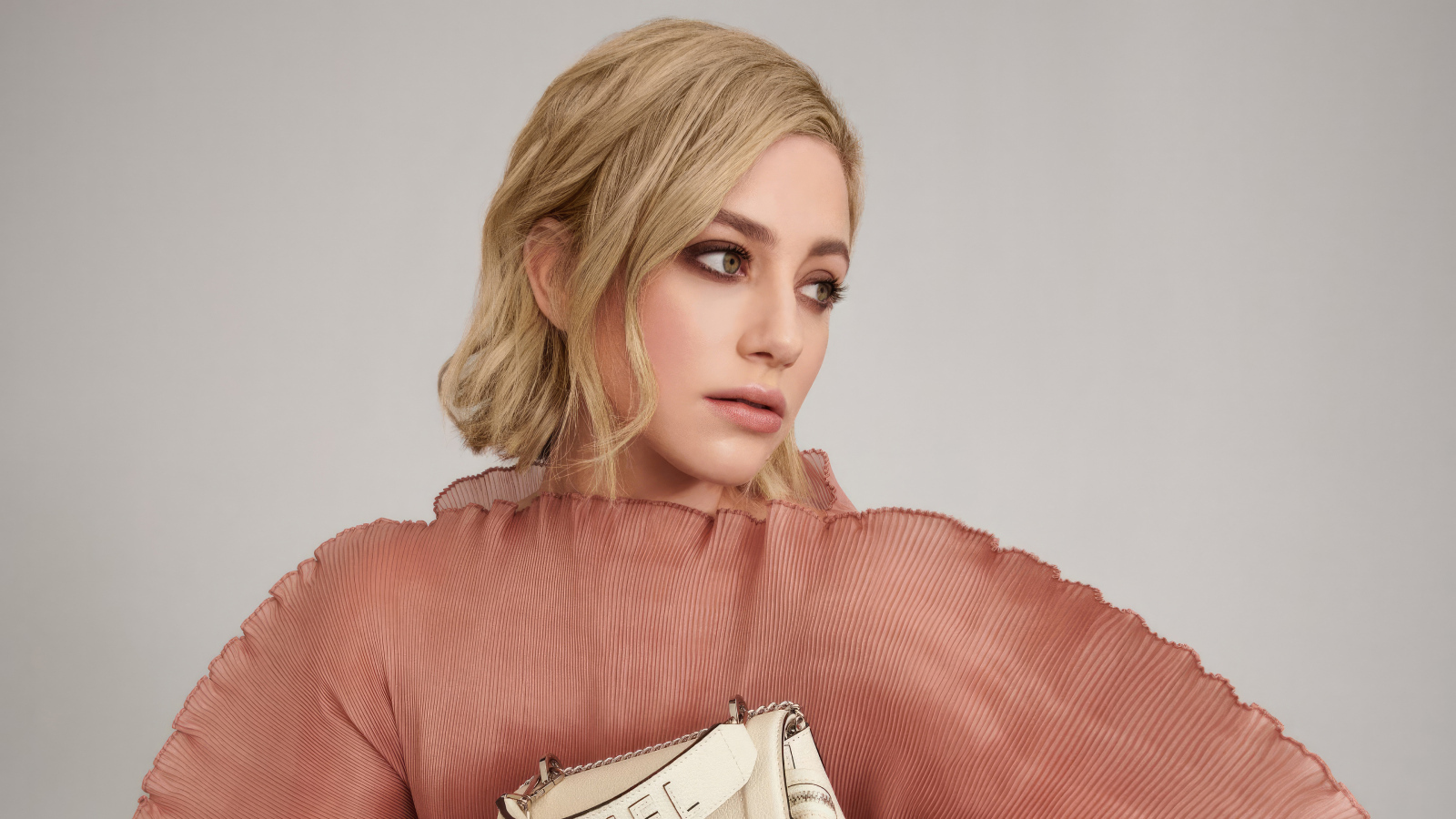 Грустный взгляд актрисы Лили Рейнхарт на сером фоне