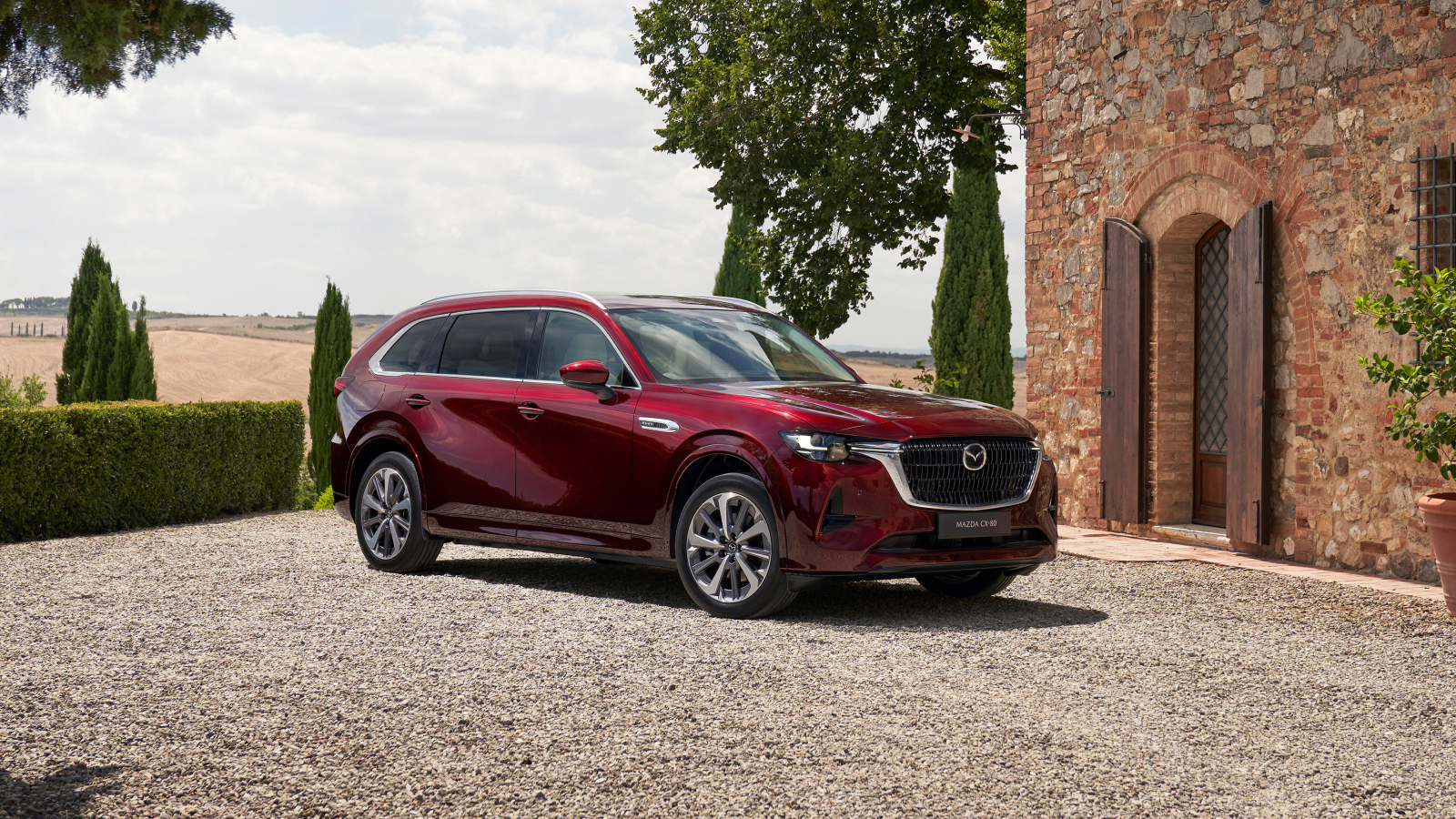 Бордовый автомобиль  Mazda CX-80 E-Skyactiv PHEV AWD 2024 года