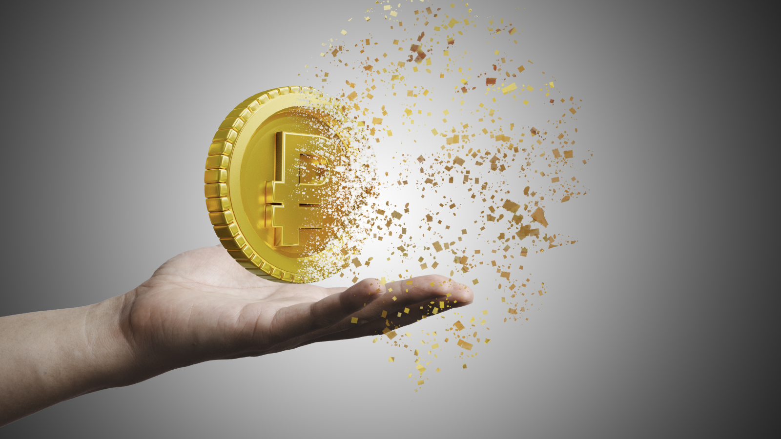 Монета разрушается на ладони на сером фоне