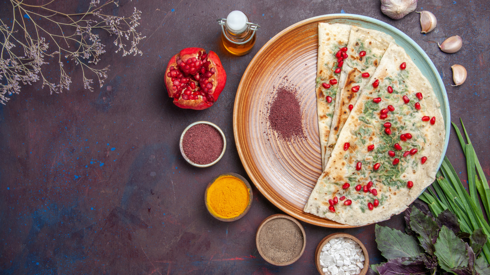 Лепешки на столе со специями и зеленью