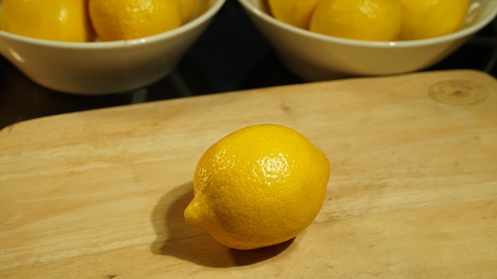 Желтый лимон на деревянной доске на столе