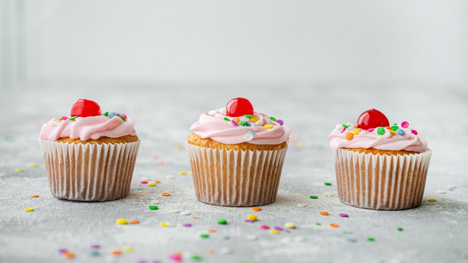 Маффины с кремом и вишней на столе