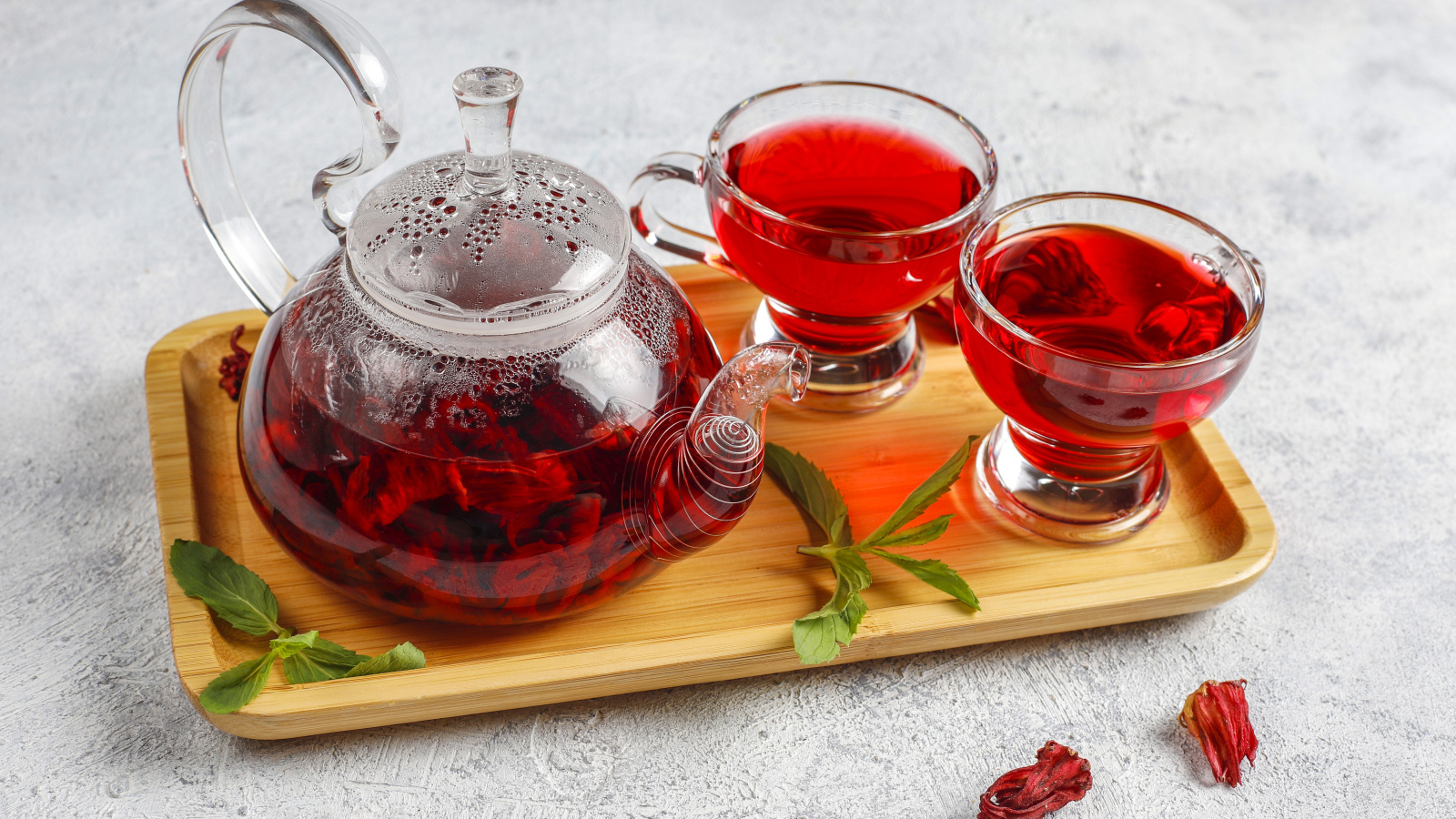 Красный чай в заварнике на подносе с чашками