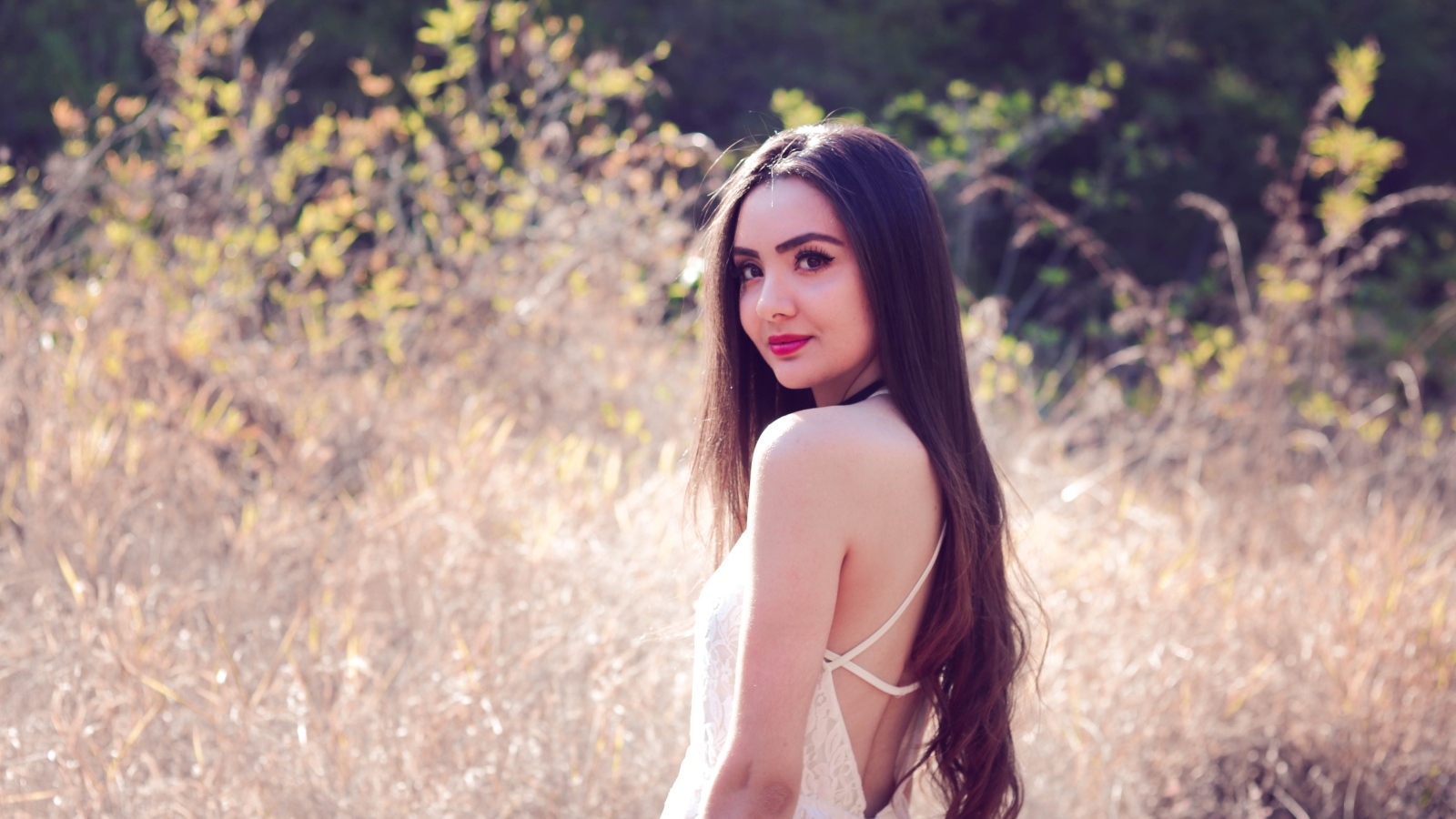 Милая длинноволосая девушка на поле 