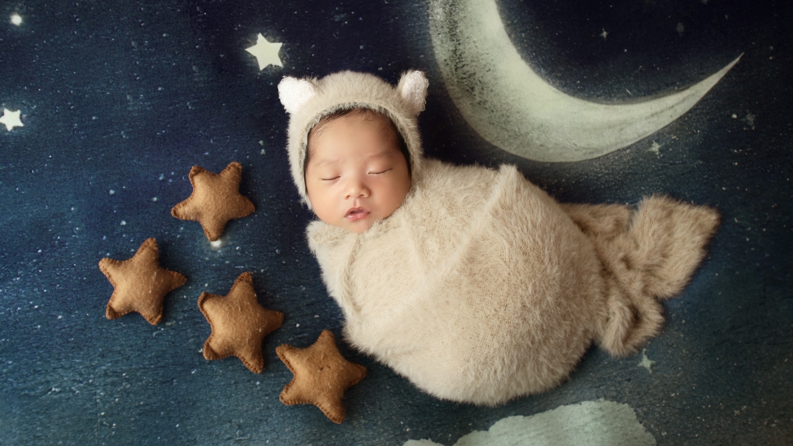 Спящий новорожденный ребенок с декором для фото 