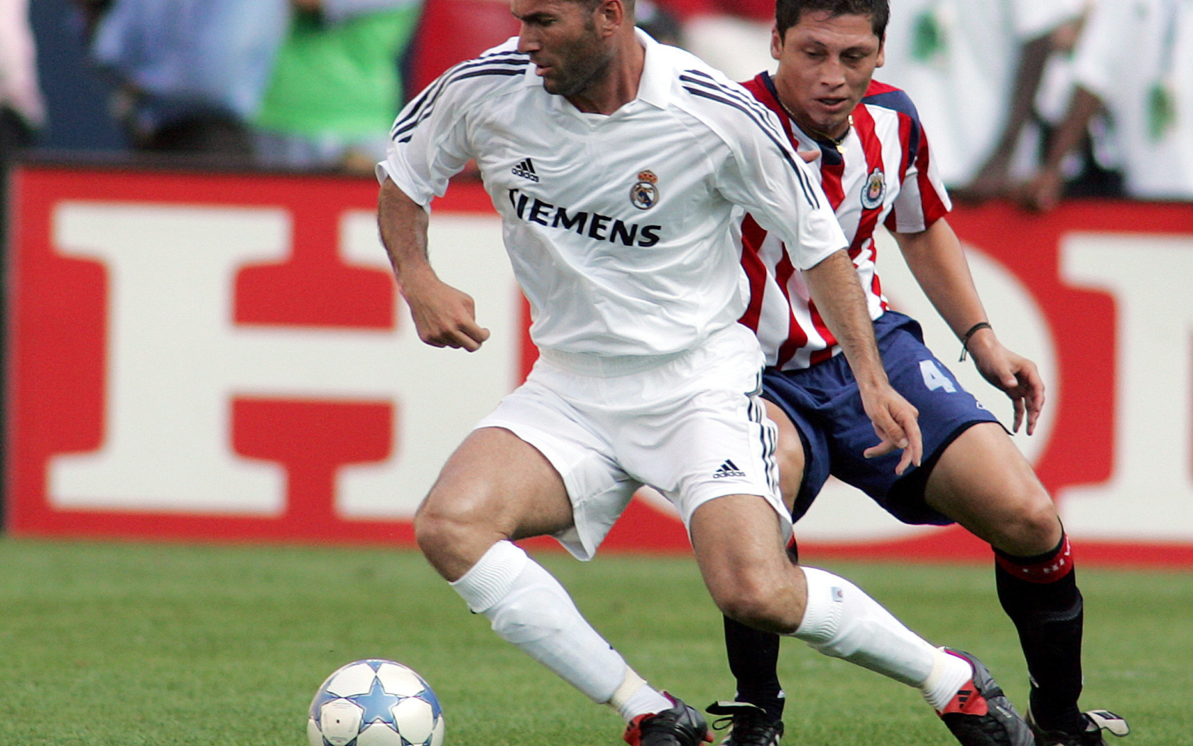 Легенда футбола Зинедин Зидан передавая мяч