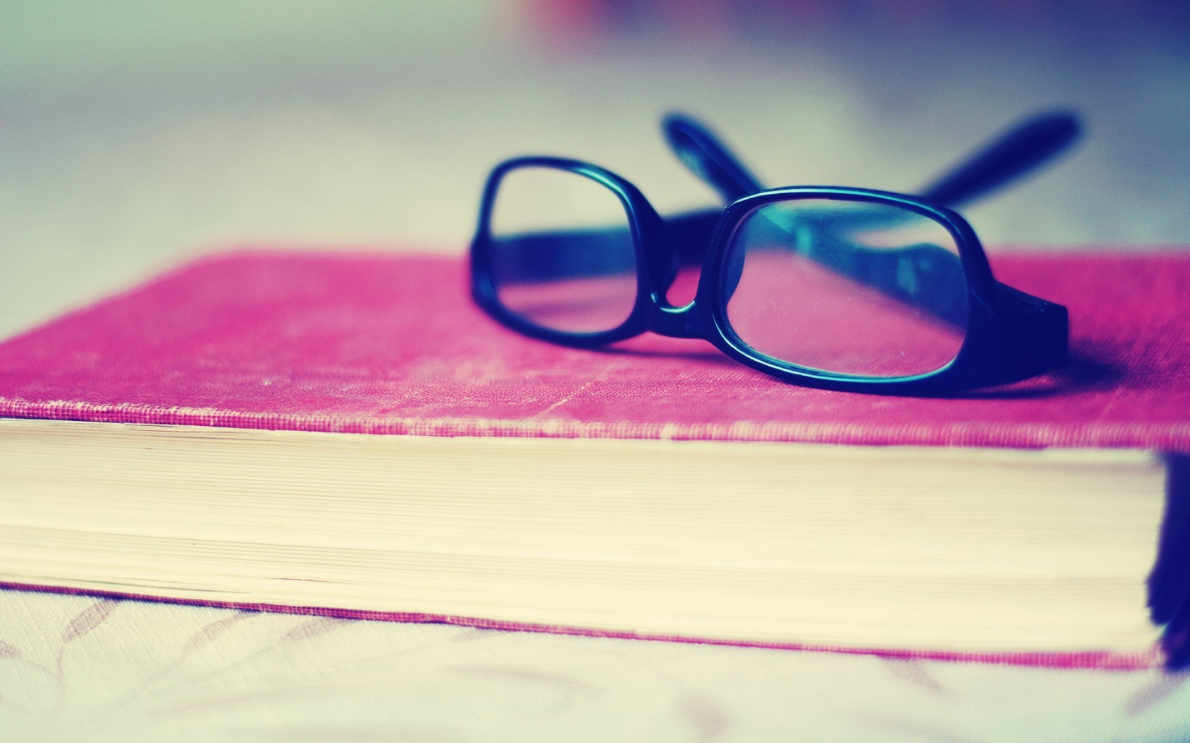 	   Glasses on the pink book