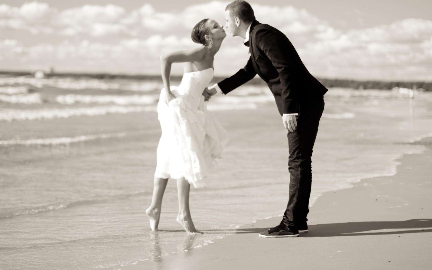 	  Kiss the groom and the bride on the beach