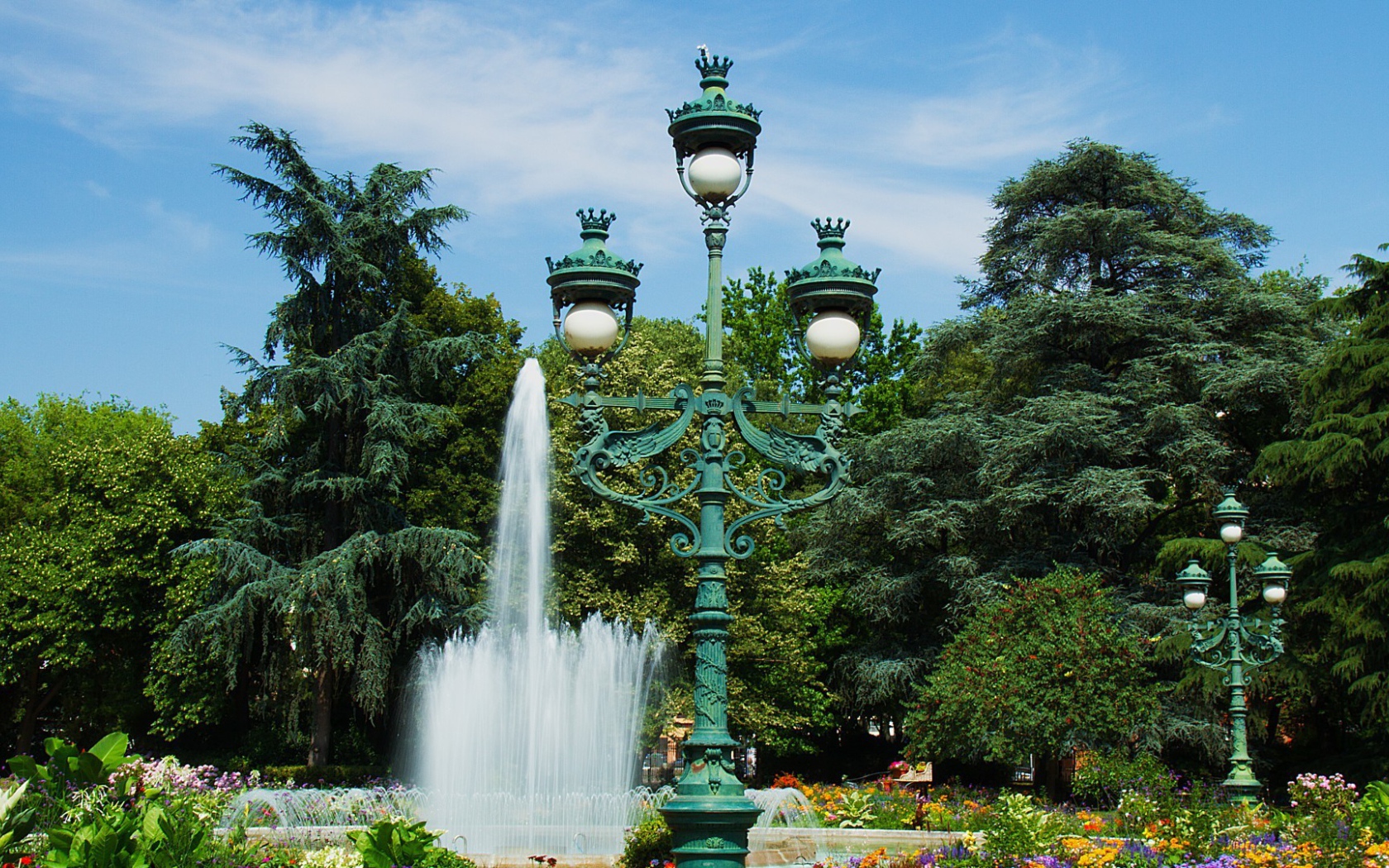 Зеленый чугунный фонарь в парке