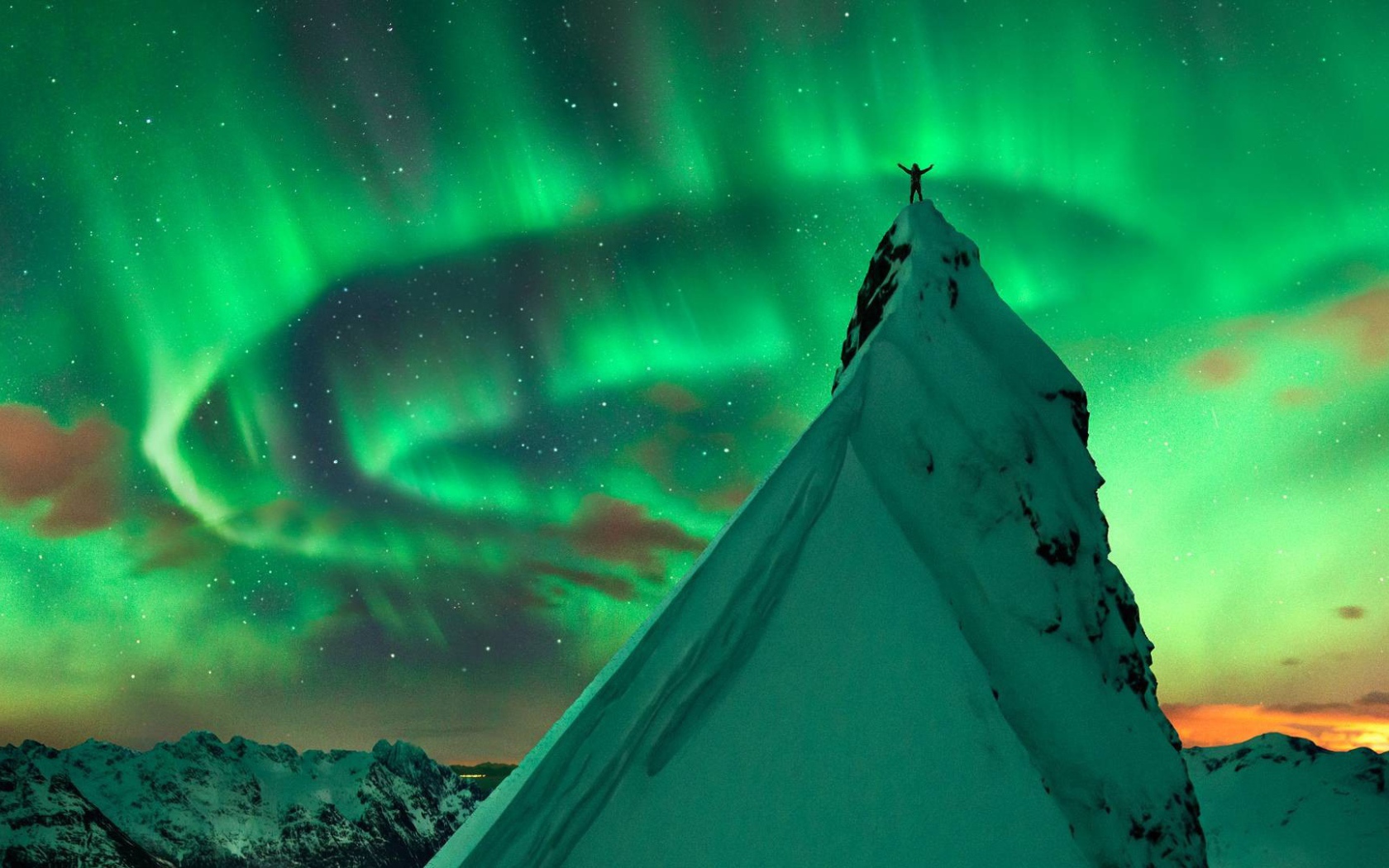 Snowy peak in the background of the Northern Lights