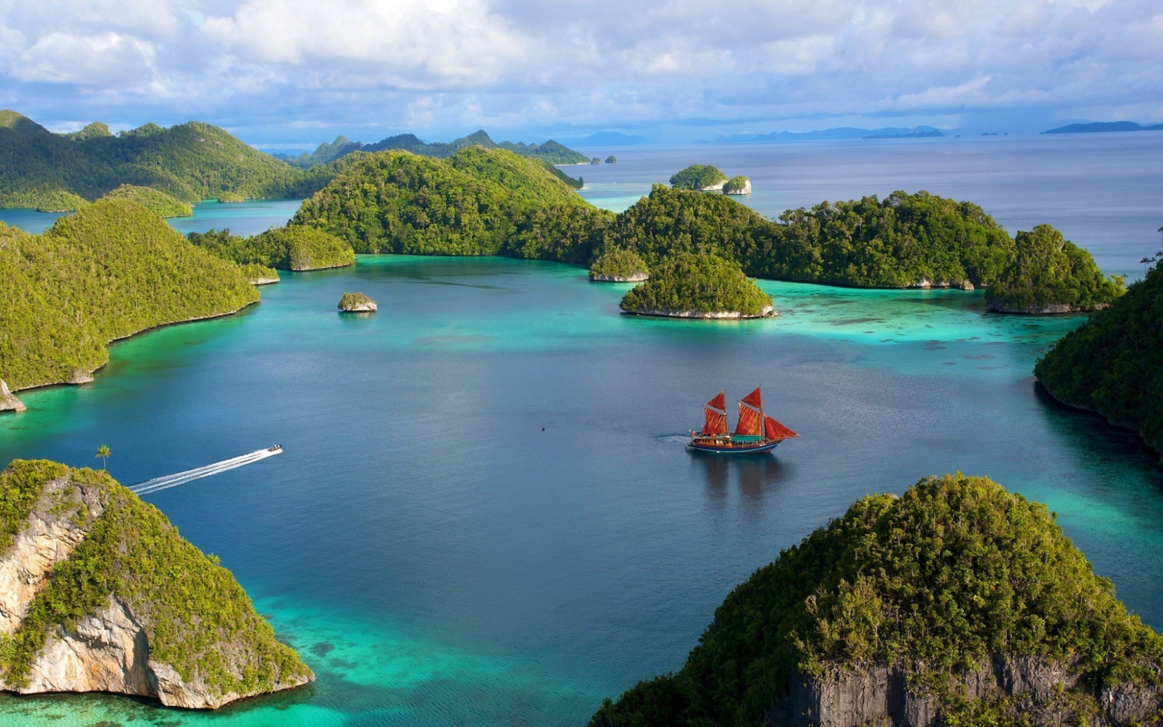 Корабль с красными парусами среди островов