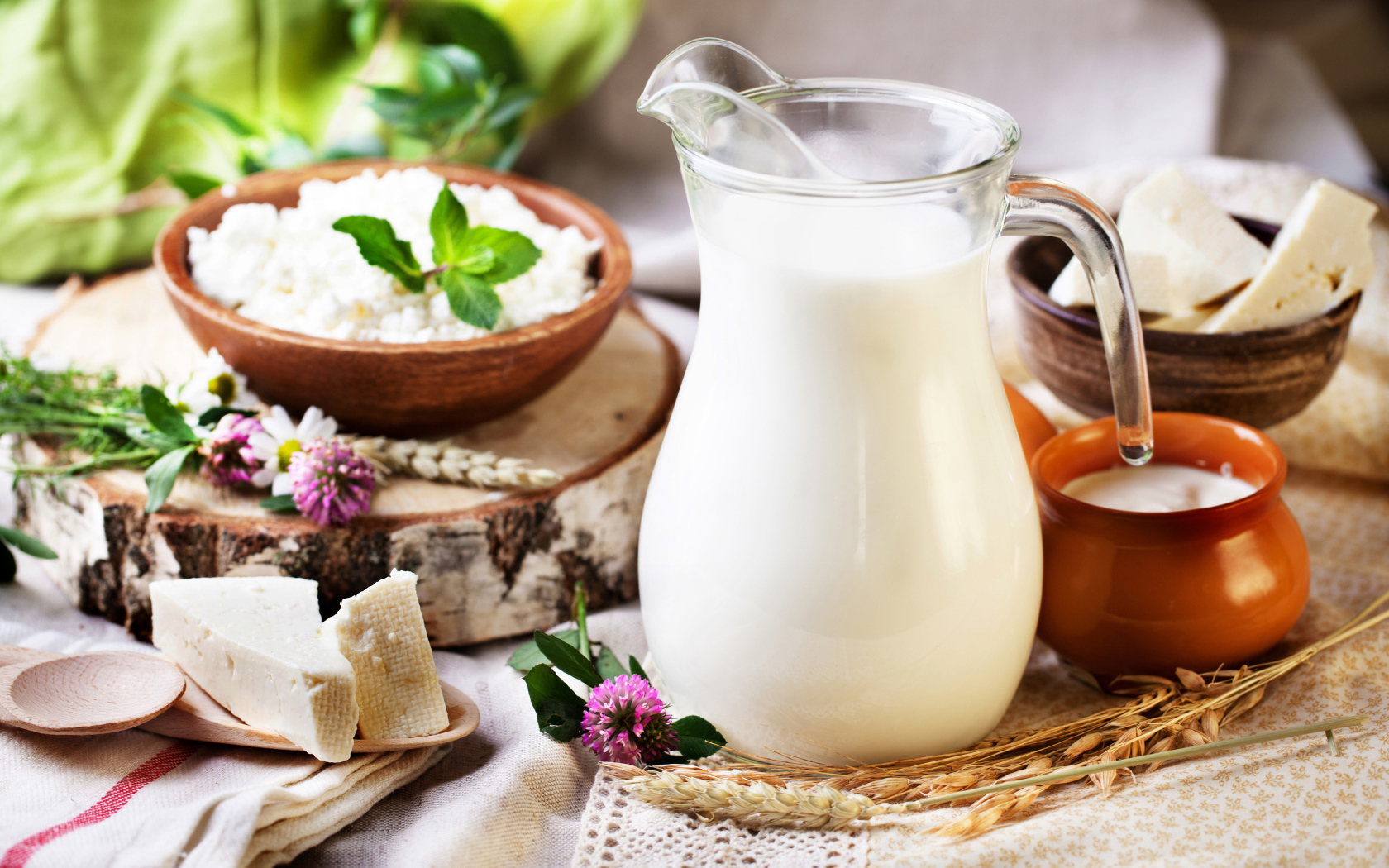 Кувшин со свежим молоком и сыр на столе