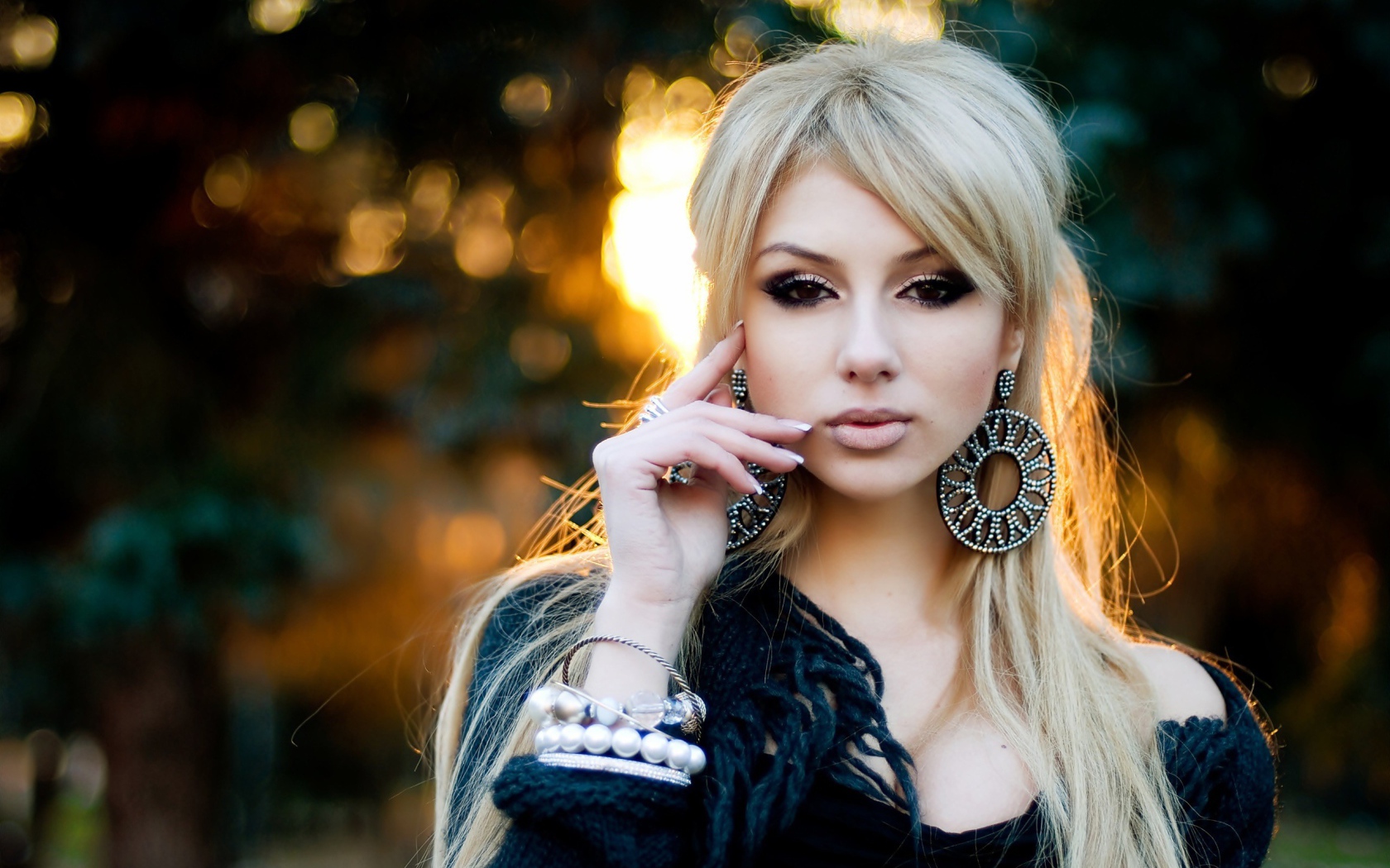 Девушка блондинка с большими серьгами в ушах 