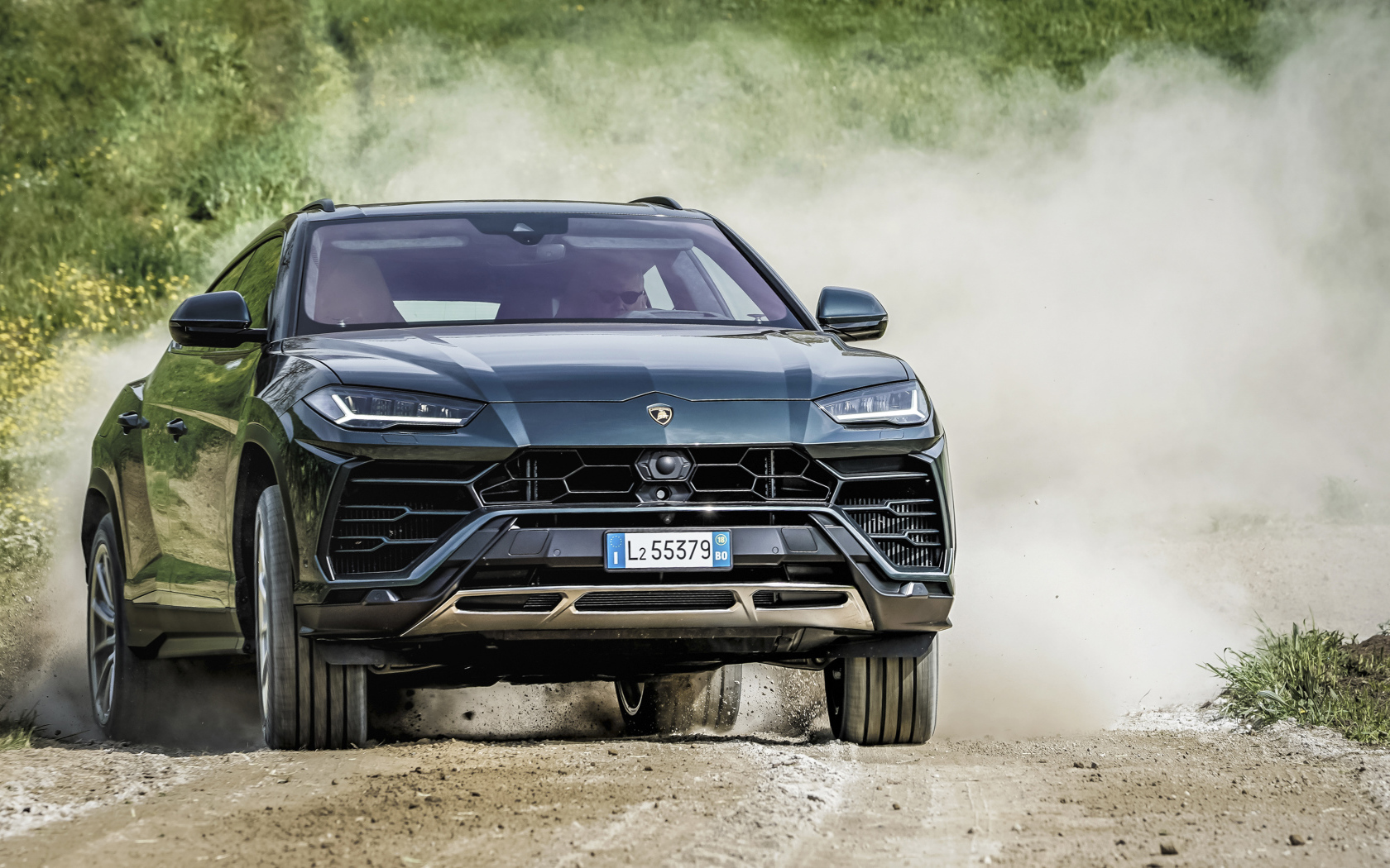 SUV Lamborghini Urus 2018 on the road in the dust Desktop wallpapers  1680x1050