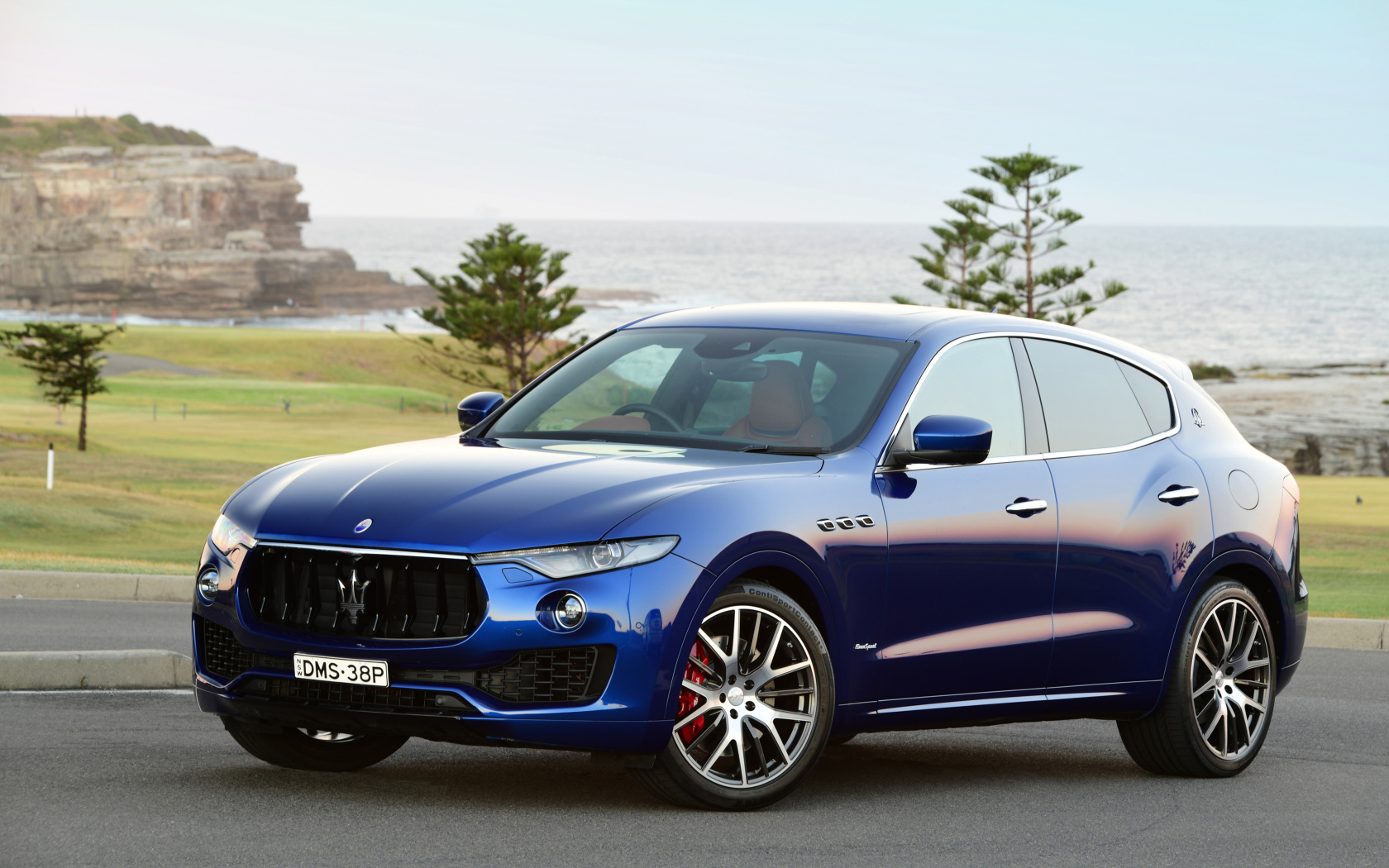 Blue car Maserati Levante on the background of the ocean