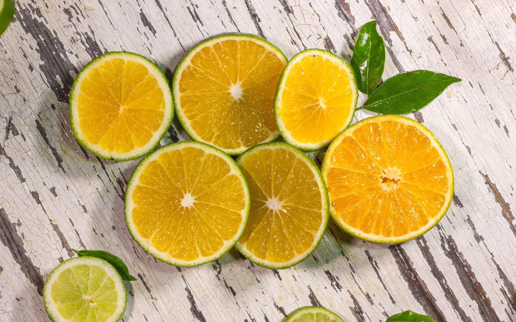 Кружочки лайма лежат на деревянном столе 