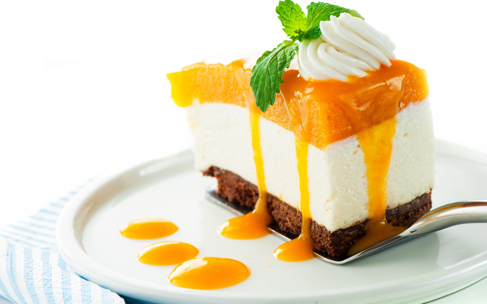 Аппетитный кусок торта с муссом и джемом на белом фоне