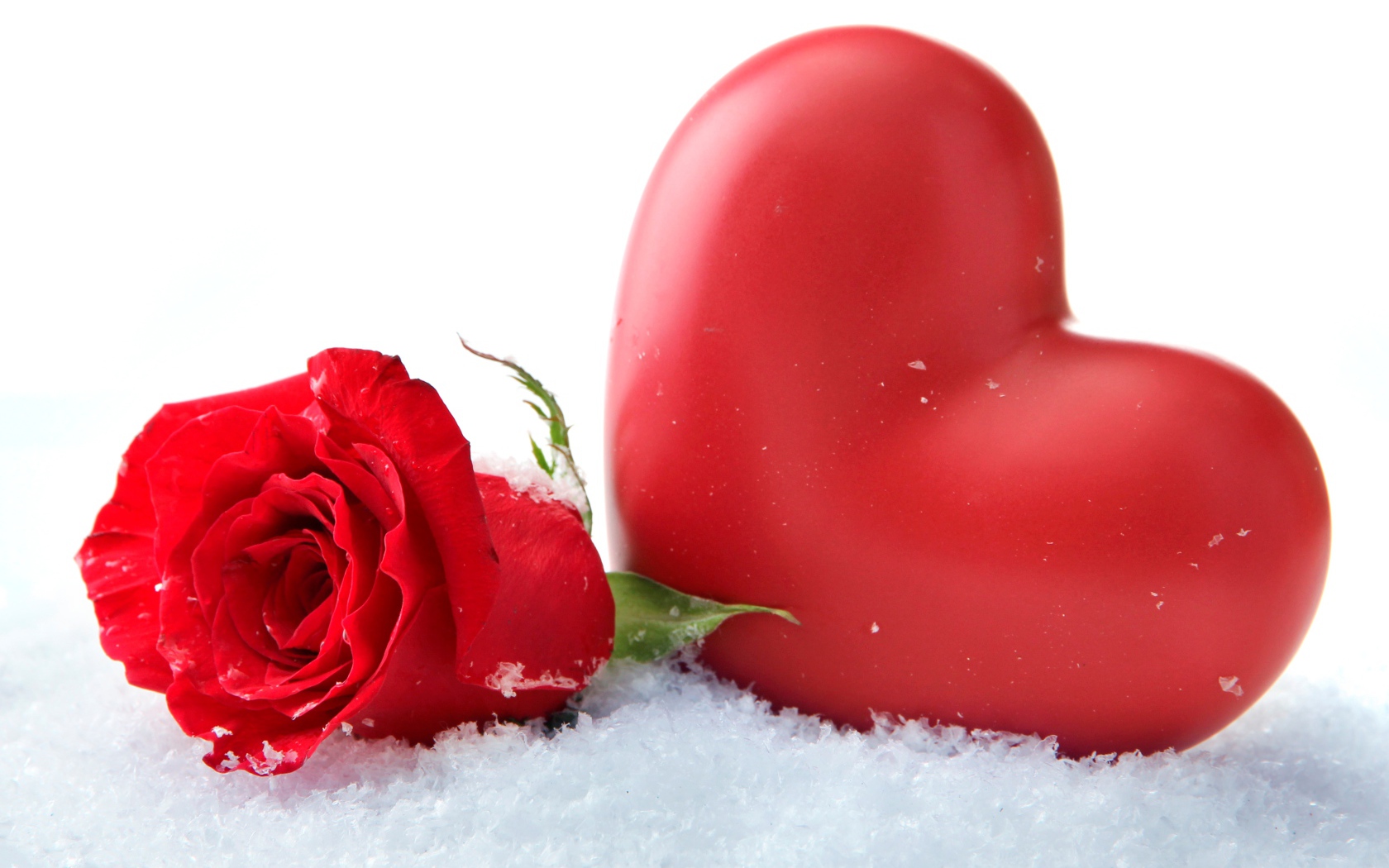 Большое красное сердце с красной розой на снегу