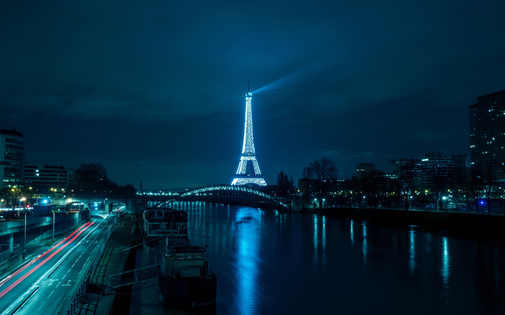 Eiffel Tower at night on the canal background, France