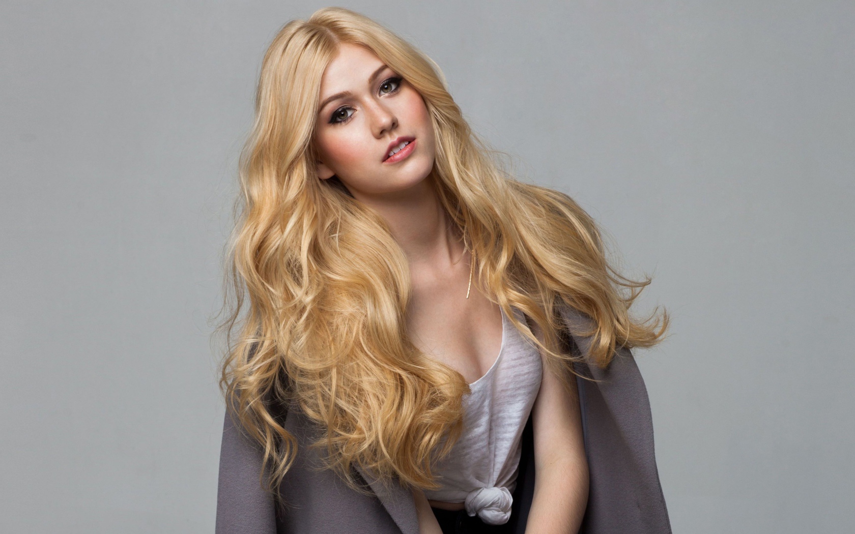 Эффектная блондинка Кэтрин Макнамара на сером фоне