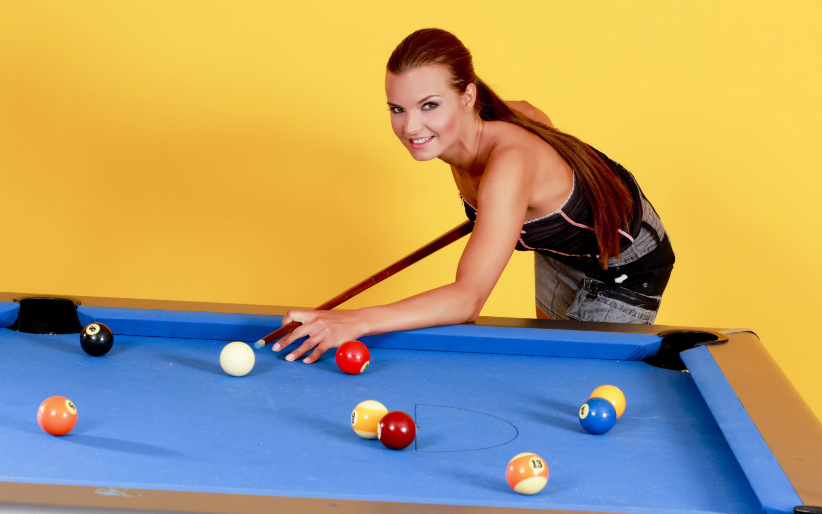Young girl playing pool