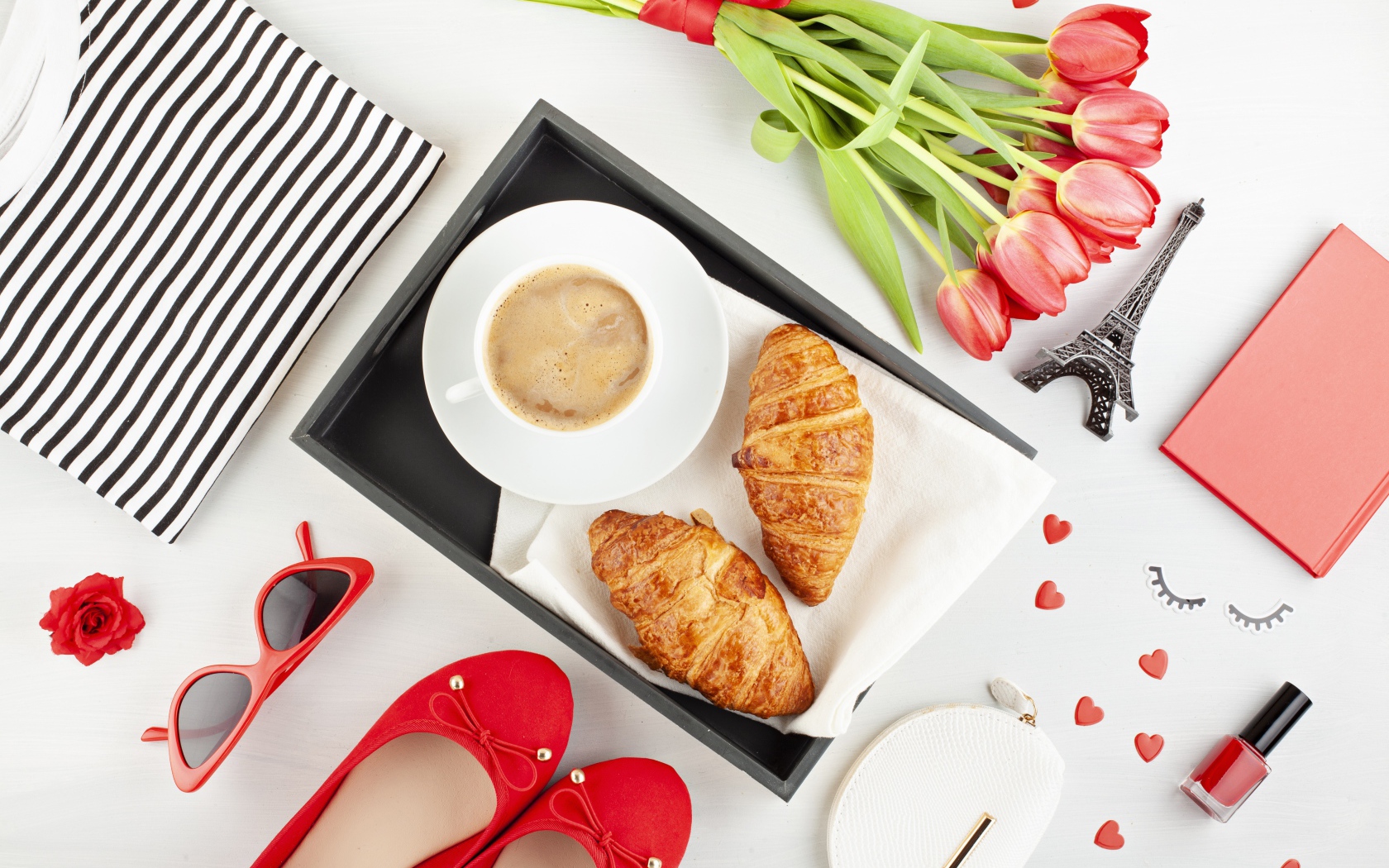 Coffee and croissants on the table with a bouquet for a loved one