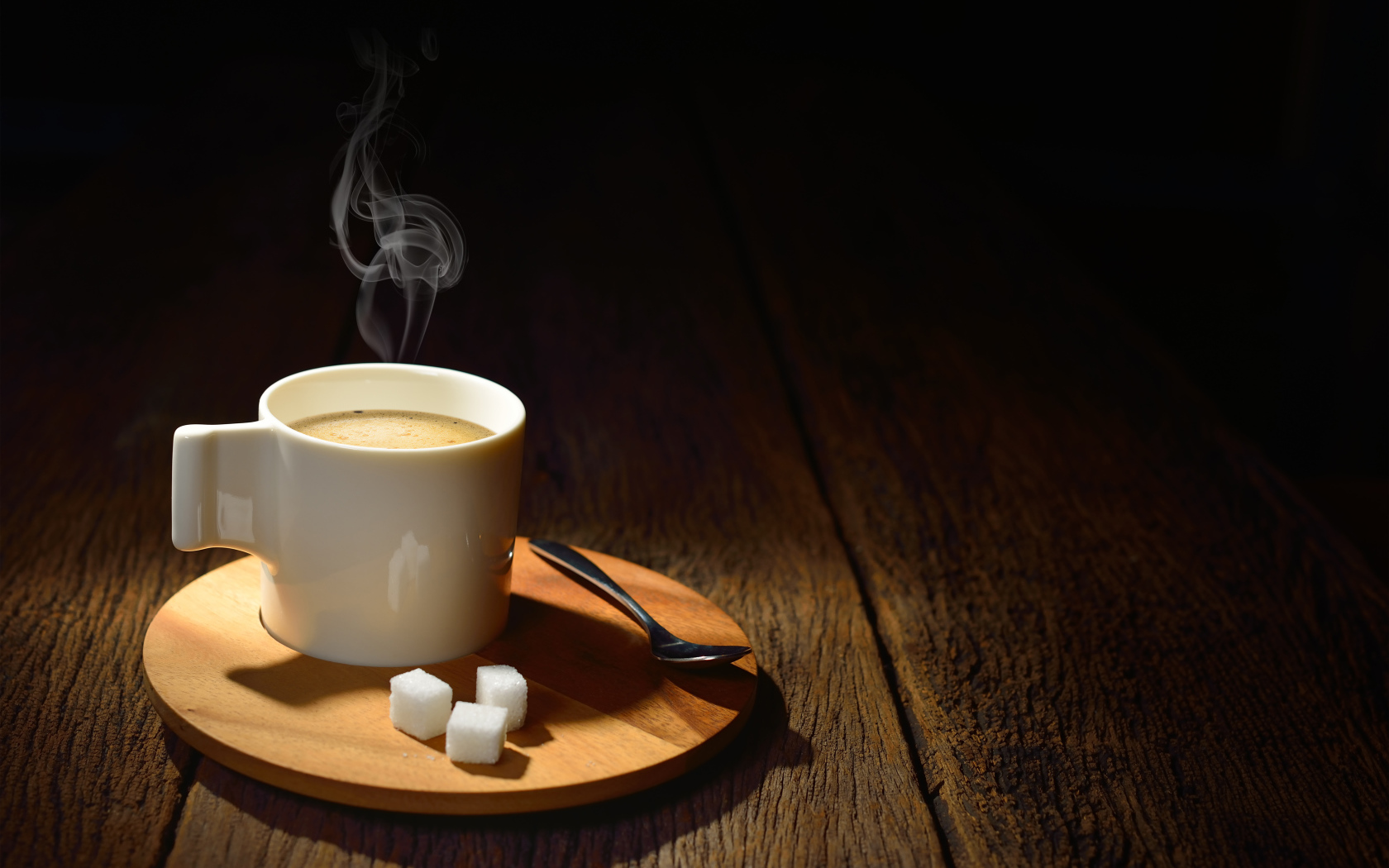 Чашка горячего кофе на столе с сахаром