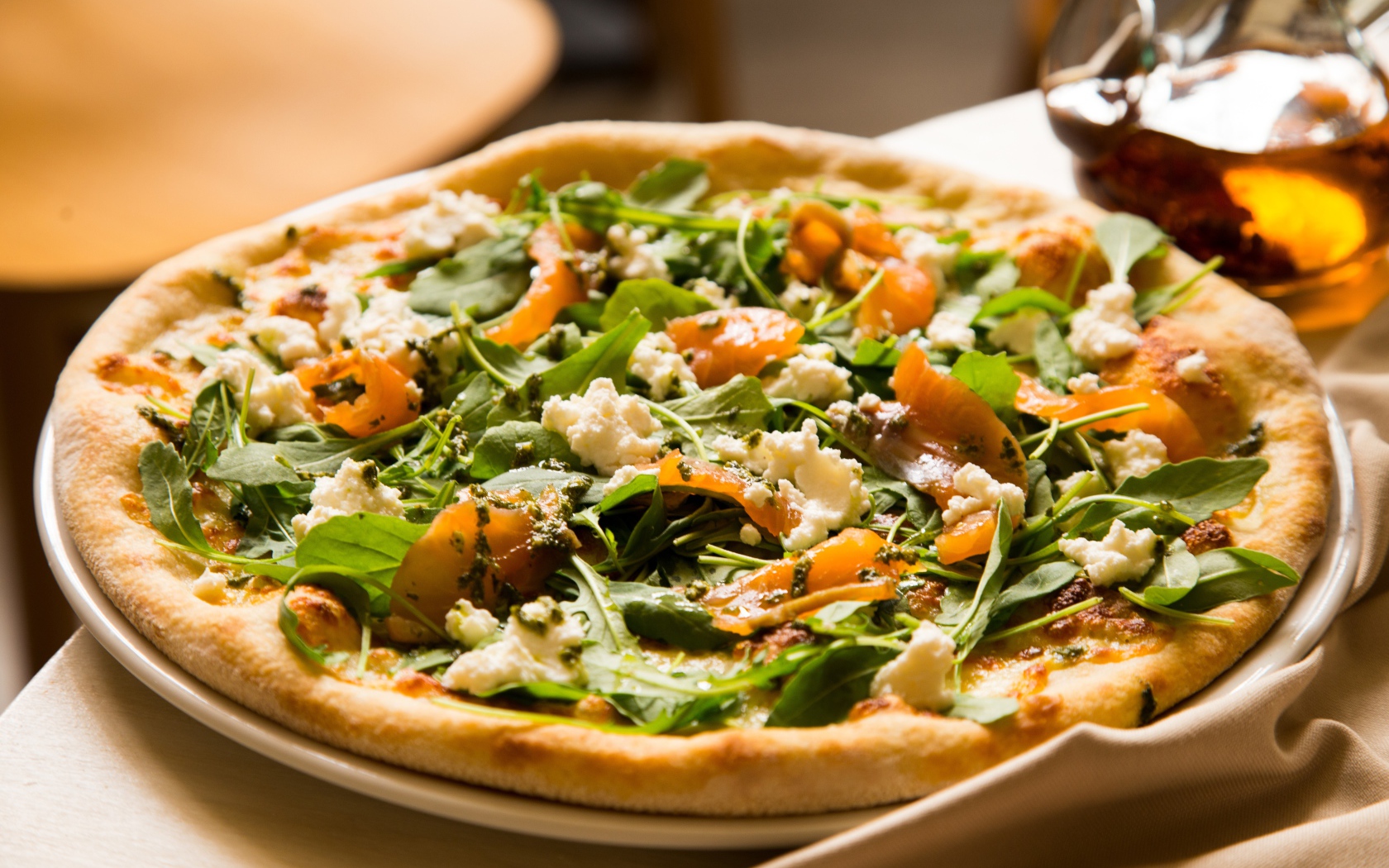 Appetizing pizza with fish and herbs on the table